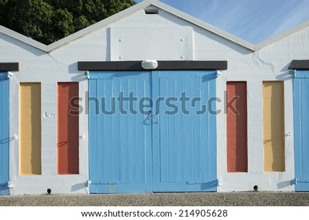 Colorful boat shed with closed blue door on Oriental Bay, Wellington, New Zealand.