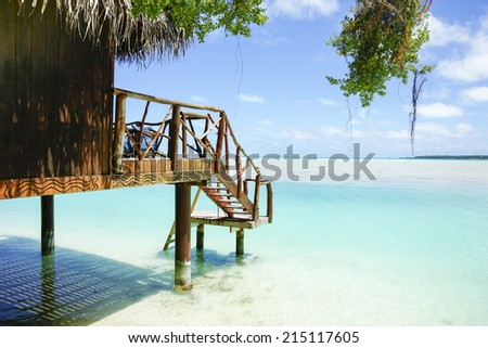 Tropical cabin over waters edge, Cook Islands, South Pacific.