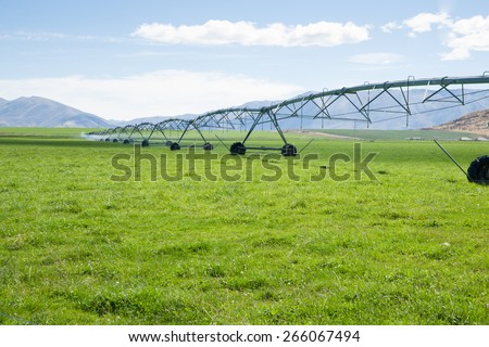 Irrigation system, long moveable booms of the water distribution plant stretches across farming fields on Otago, New Zealand.