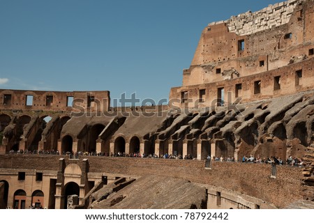 Colosseum, Italy\'s most popular tourist attraction, with tourists dwarfed by its scale.