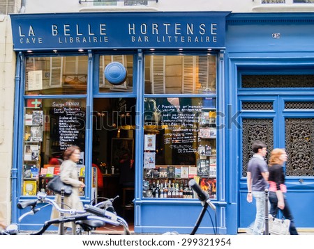 PARIS, FRANCE - JUNE 21; La belle Hortense famous wine bar and bookshop in Marais District Paris France with people walking past the open door on June 21, 2009 in Paris France.