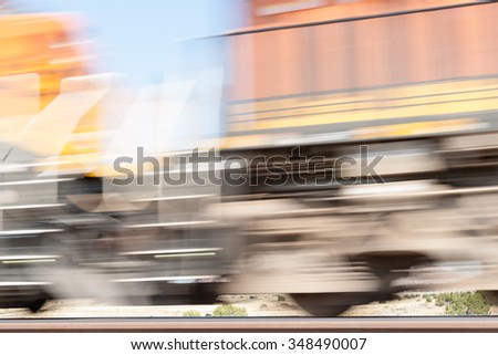 New Mexico high plains industrial abstract fast moving train in motion blur alongside Route 66.