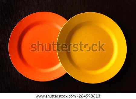 Empty Plate - Orange and yellow around empty plate on wooden background.