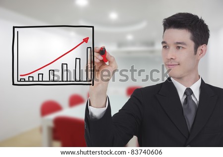 Businessman drawing a rising arrow, representing business growth.
