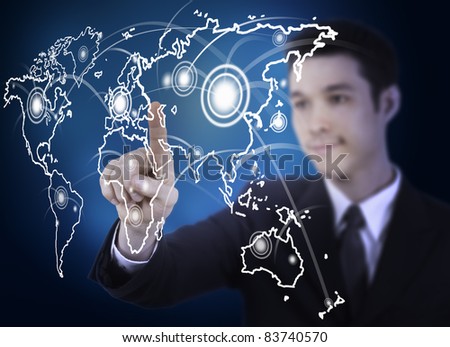 business man pressing a world map touchscreen