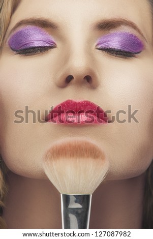 closeup portrait of blond young woman with closed eyes and fashion makeup, shot of high end retouching
