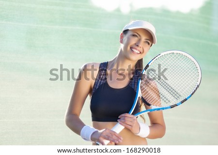 Portrait of Pretty Young Caucasian Female Tennis Player on Tennis Court. Horizontal Image