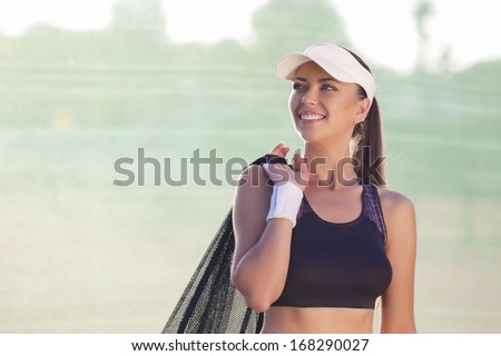 Professional Tennis Athlete with Tennis Mesh On Court Smiling. Healthy Lifestyles Concept. Horizontal Image