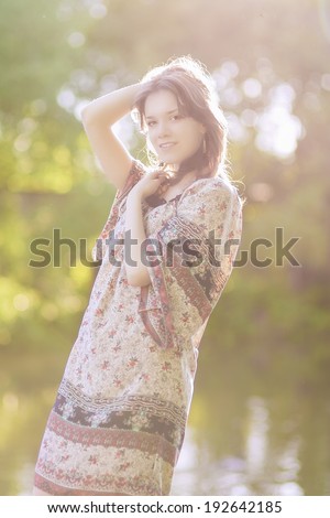 Portrait of Dreaming Sensual Romantic Girl Outdoors. Model With Long Stylish Hair Against Nature Background. Vertical Image