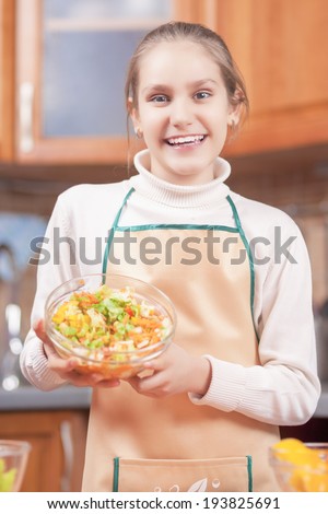 Laughing Teenage Girl Showing the Homemade Organic Vegetable Salad. Vertical Image