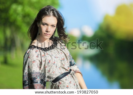 Sensual Caucasian Girl Outdoors Posing Against River. Sunshine Weather. Shallow Depth of Field. Horizontal Image