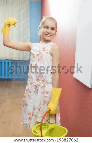 Funny Beautiful Little Teenage Girl With Cleaning Tools in the Kitchen. Vertical Image