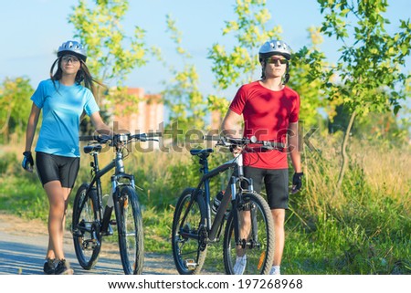 Caucasian Cycling Athletes Exercising Relaxing During their Exercise in Nature Environment Outdoor. Horizontal Image