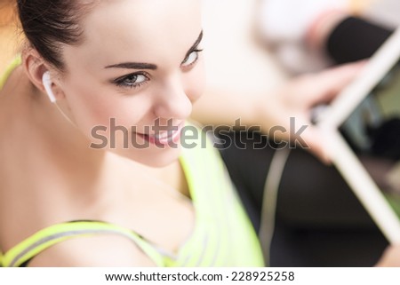 Portrait of Smiling Sensual Woman with Earphones. Shallow Depth of Field. Horizontal  Image