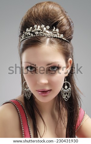 Portrait of Sexy and Sensual Caucasian Young Female with Crown. Vertical Image Orientation