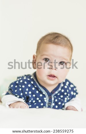 Natural Portrait of Positive Caucasian Newborn Girl. Vertical Image