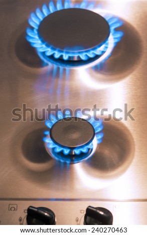 Two Gas Burners with Regulator Valves on Stove Surface. Vertical Image