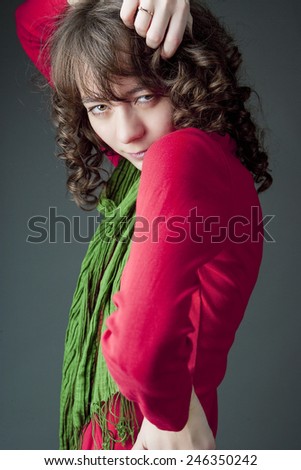 Caucasian Woman with Long Green Scarf Posing Over Gray Background. Vertical Image Composition