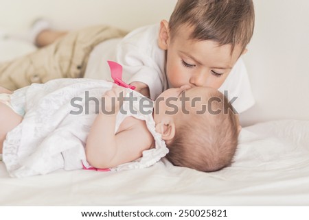 Little Caucasian Boy Kissing His Newborn Sister. Indoors Shot. Horizontal Image