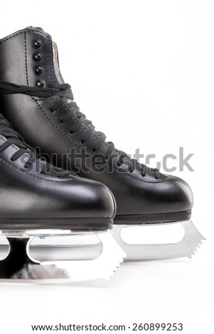 Figure Skating Concept: Closeup Shot of Professional Mens Figure Skates Isolated Over White Background. Vertical Shot