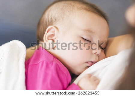 Little Cute Caucasian Infant Sleeping on Mothers Hands Indoors. Horizontal Image Composition