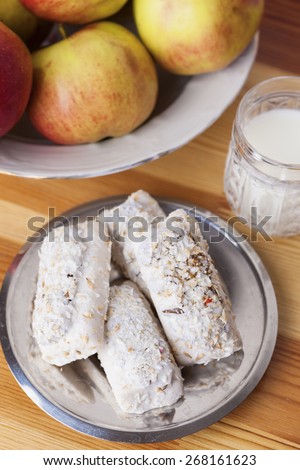 Homemade Tasty Milk Cookies with Cream Dressings and Condensed Milk Filling against of Glass of Milk on Wooden Background. Vertical Image