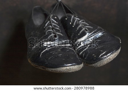 Closeup Shot of Pair of Worn-out Standard European Ballroom Dance Shoes. Against Black Background. Horizontal Image Orientation.