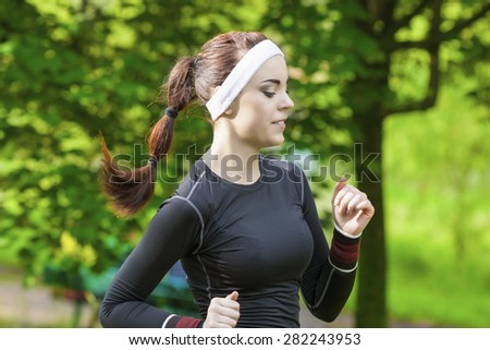 Portrait of Smiling Caucasian Sportswoman Having Her Regular Training Outdoors. Horizontal Image Orientation