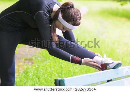 Young Caucasian Woman Having Stretching Exercises Outdoors. Horizontal Image Orientation