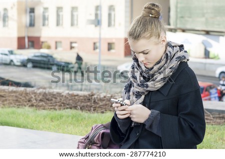 Lifestyle Concepts: Trendy Teenager Girl Using Cellphone Outdoors.Horizontal Image Orientation