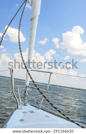 Bow of the Small Yacht Under Sailing On Open Waters. Vertical Image Orientation
