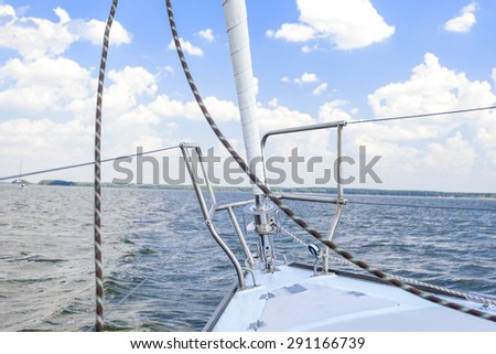 Bow of the Small Yacht Under Sailing On Open Waters. Horizontal Image Orientation