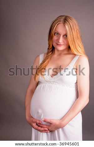 stock photo pretty young pregnant blonde in white nightshirt isolated