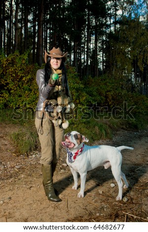 young caucasian brunette girl with her bulldog playing with small tennis ball and puckering because of dog\'s saliva.  dog with american flag as neckpiece. shoot made on location with flash
