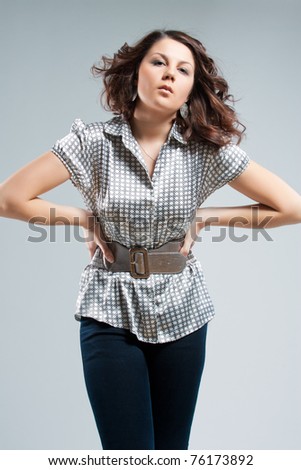 young and sensual caucasian brunette girl standing posing over white background with body shaped