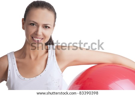 young caucasian girl exercising with fitball having positive facial expression, isolated