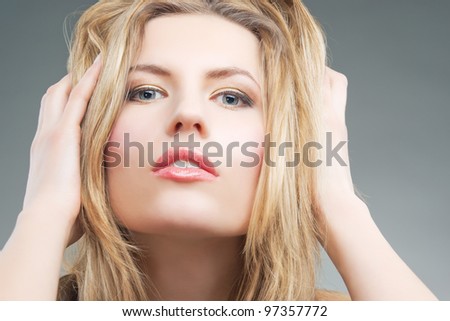 passionate blonde woman with hands lifted and staring