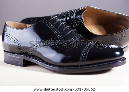 Footwear Concept. Pair of New Black Stylish Male Oxfords Lacqured Semi-Brouge Laced Shoes. Horizontal Image