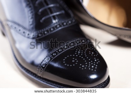 Closeup of Pair of Male Stylish Black Polished Oxford Semi-Brogue Laced Shoes. Horizontal Image Orientation