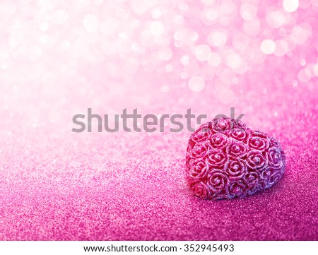 Glittering heart shaped with rose craft over pink bokeh background