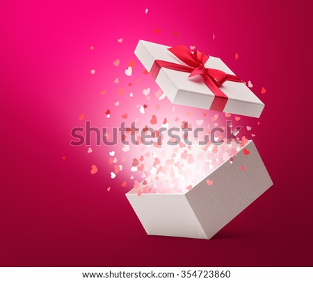 Hearts confetti popping out from white gift box