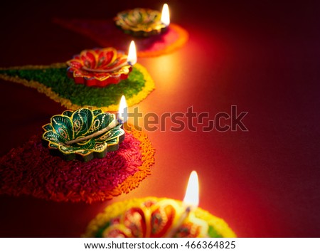Diwali oil lamp - Colorful clay diya lamps lit during diwali celebration