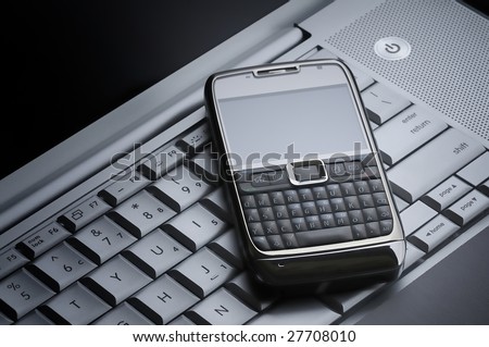 smart cell phone on a silver laptop