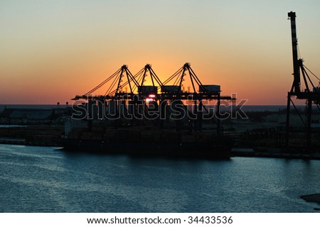 construction silhouette of cranes on sunset background