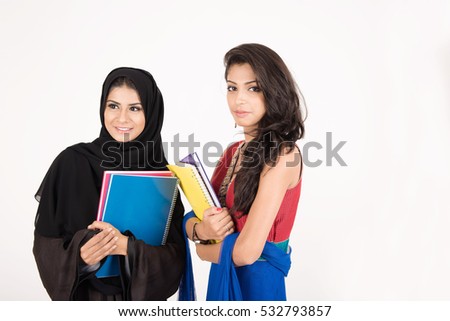Female students in traditional dresses from different cultures on white background