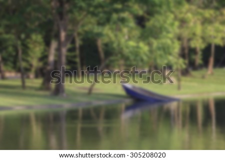 Blurred Background - A Boat sinking in the lake at park.