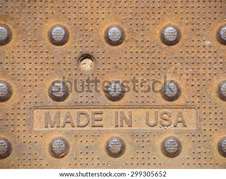 A heavy, rusty steel plate proudly stamped made in USA at the foundry.   It also has interesting dot patterns that provide traction for walking on.
