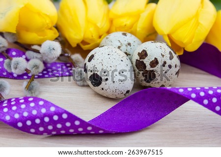 Quail eggs on the table with flowers and ribbon, tape
