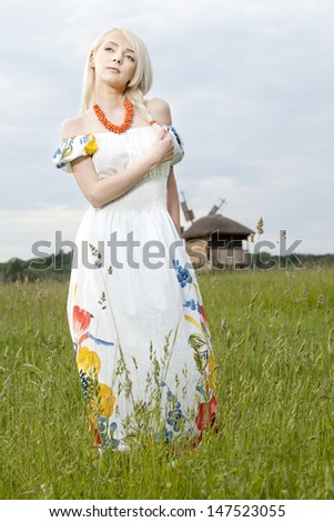 21 Mpix full-frame HD-capture. Professionally retouched. Young rural woman standing at the green field