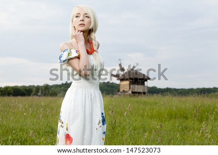 21 Mpix full-frame HD-capture. Professionally retouched. Young rural woman standing at the green field